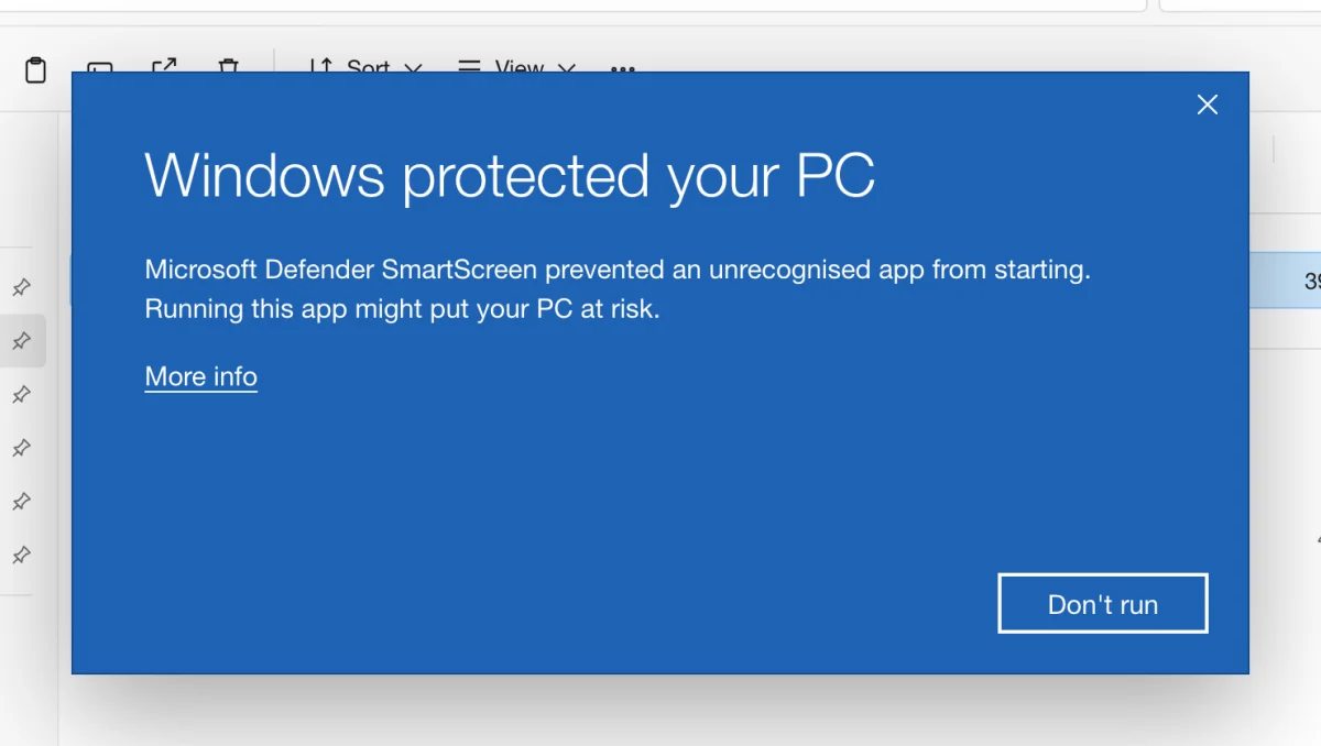 A drawn picture of the blue Windows protected your PC box over File Explorer: Microsoft Defender SmartScreen prevented an unrecognised app from starting, a More info link under the text and a Don't run button; an arrow points to the outlined More info link.