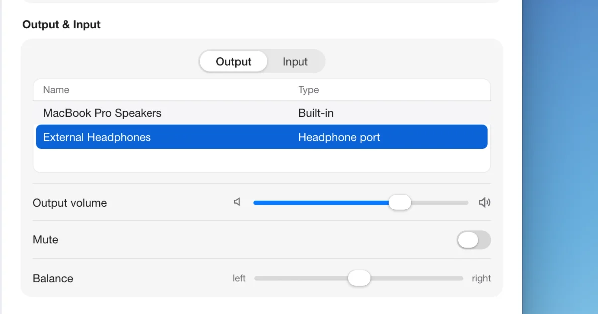 A drawn picture of System Settings on a Mac at Sound, Output and Input, with Output chosen and the list showing MacBook Pro Speakers and External Headphones, the headphones selected, and the output volume slider below; the device list is outlined and an arrow points to the selected headphones.